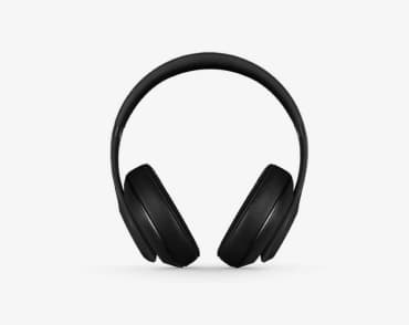 image of full coverage all black headphones close up against an off-white background